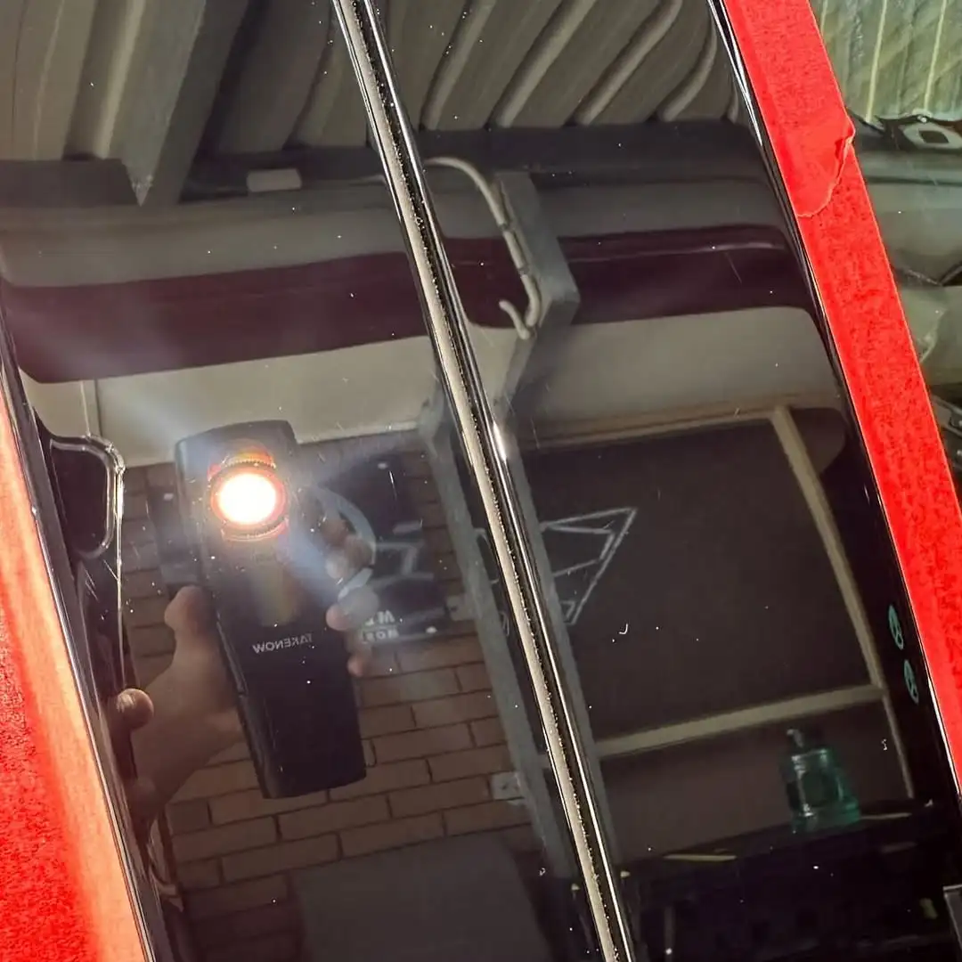 Car paint after correction showing a flawless, mirror-like finish