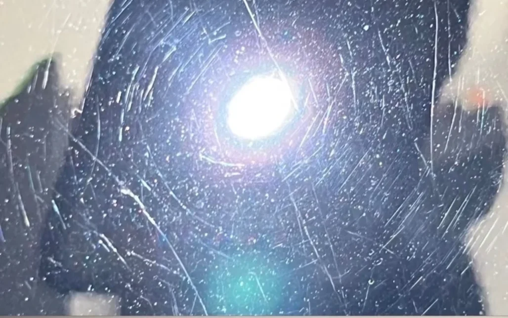Swirled paint under torch light before correction